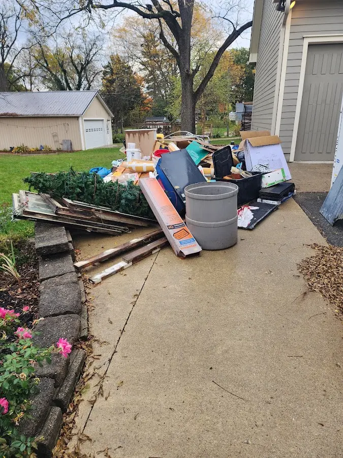 Dumpster being loaded with debris for 12 Yard Dumpster Rental in North College Hill